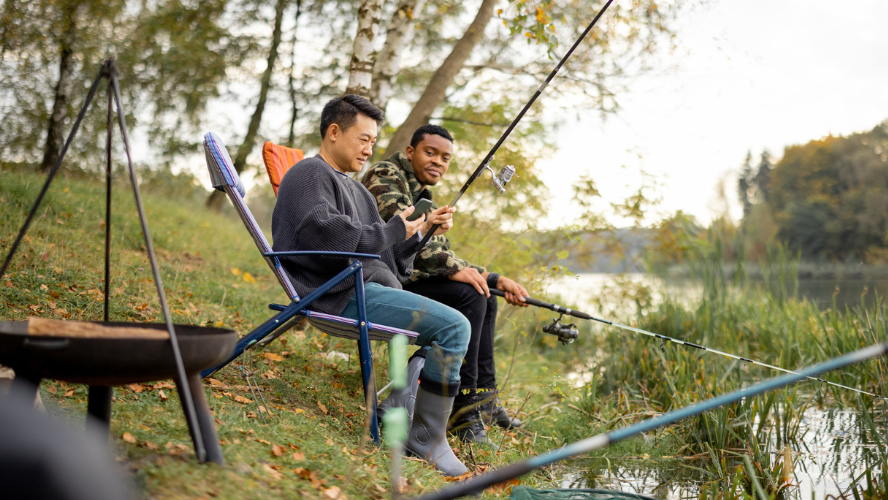 Two men are fishing together.