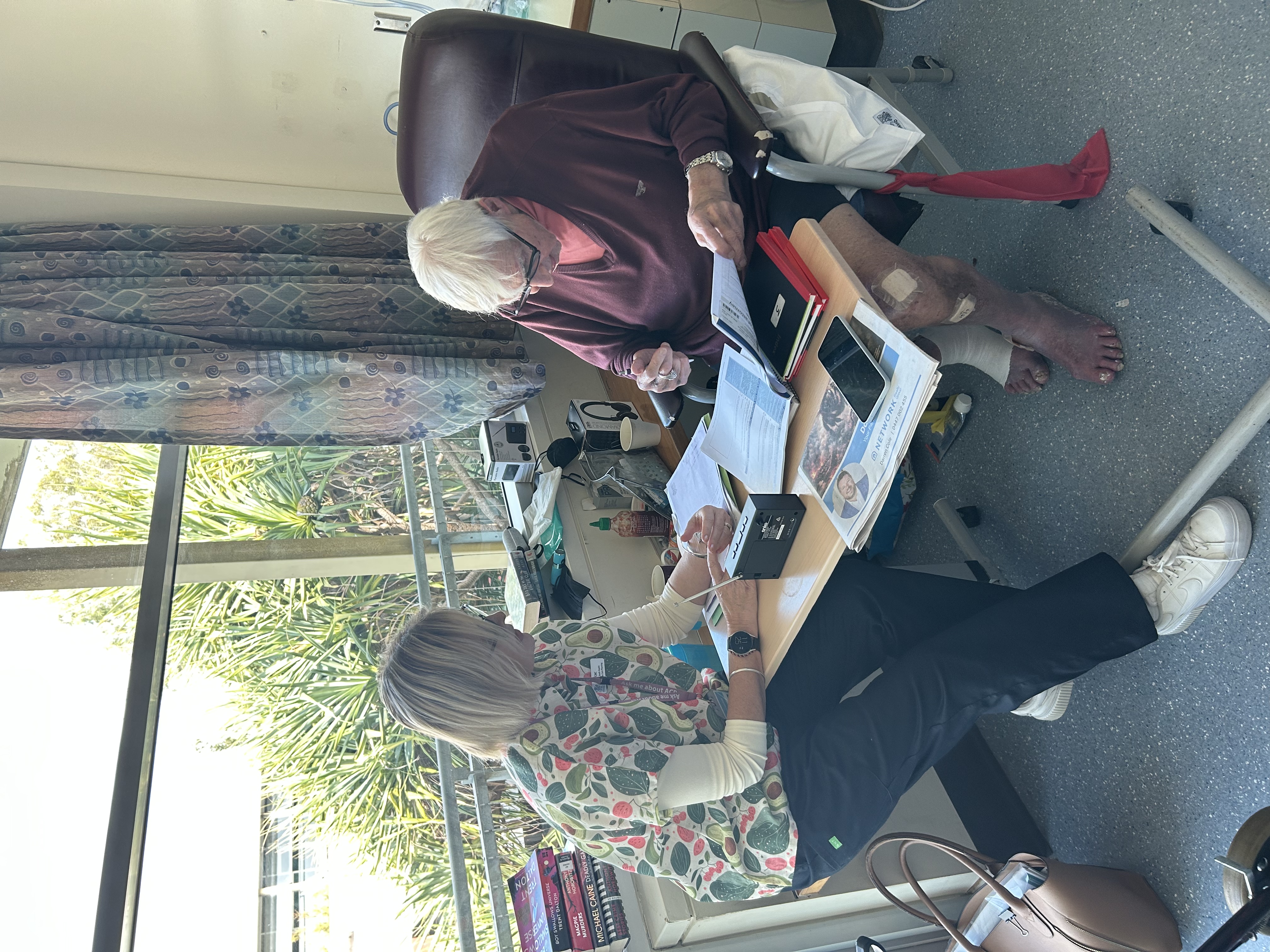 Lisa helping Barry complete his ACP forms in hospital