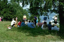 a group of people having a picnic in a park