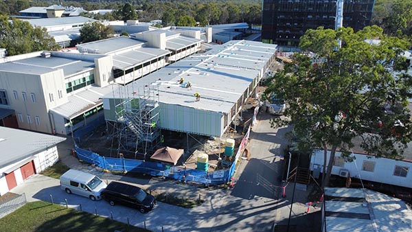 You can see the new 28 bed modular ward in the middle of the image. It is located behind the main hospital, which is to the left of the image. Scaffolding and blue hoarding are at the front of the ward.