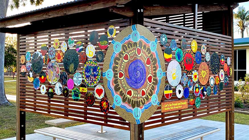 A colourful outdoor mural of decorated circles by local artists in Biloela, Woorabinda and Blackwater.