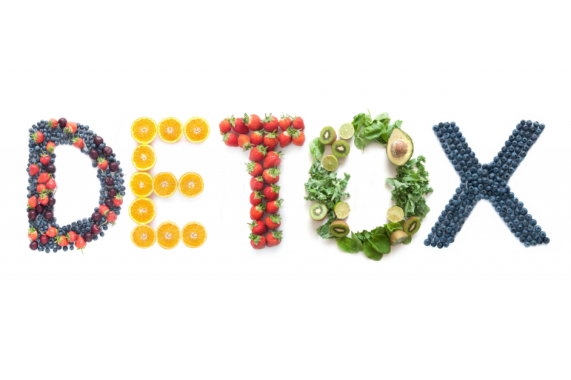 The word 'detox' spelled out using berries, oranges, strawberries, greens and blueberries for each letter