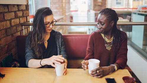 Two people talking in a coffee shop