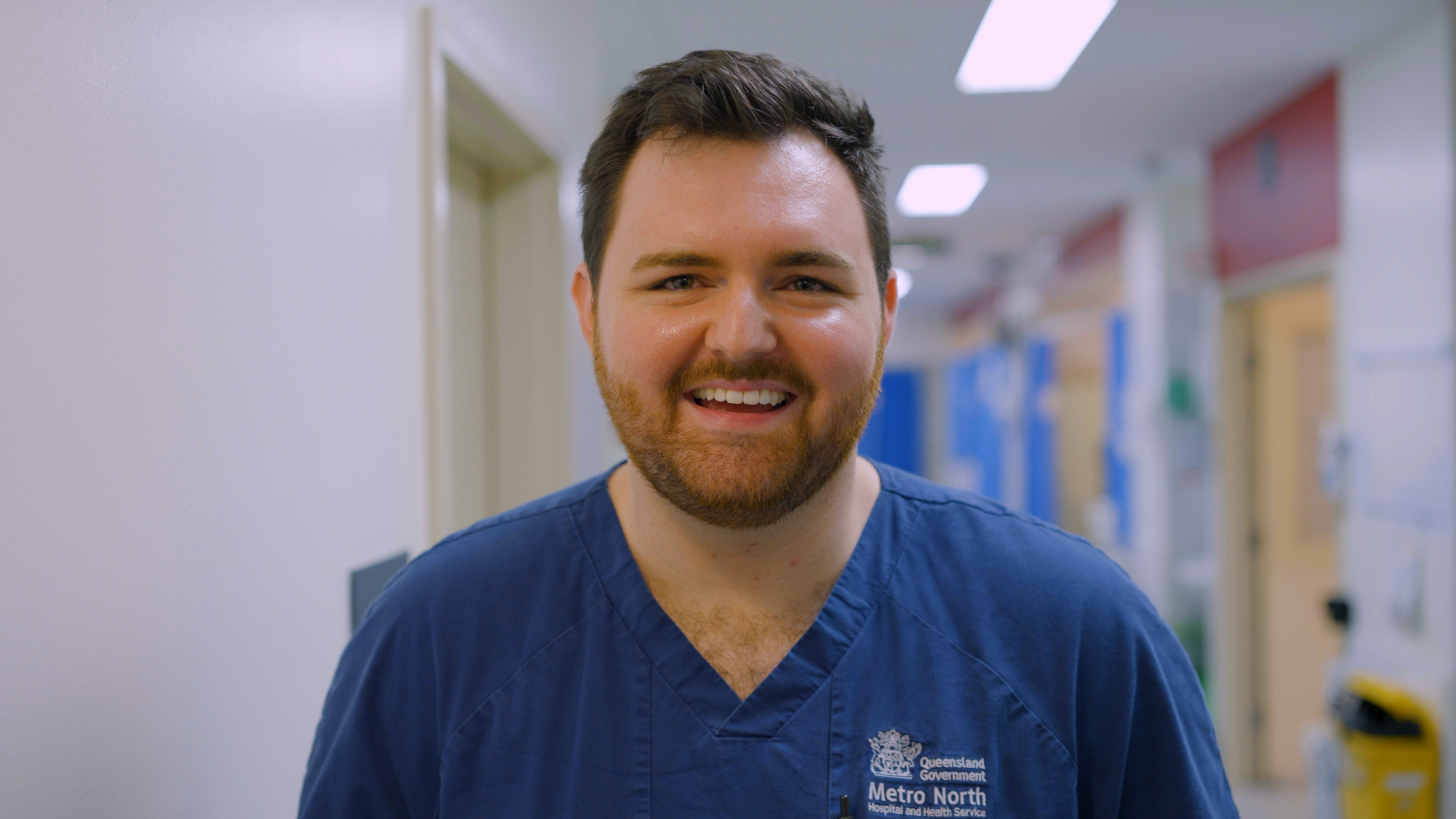 male nurse smiles at the camera
