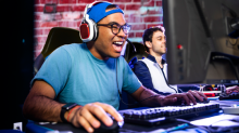 An excited looking young man playing an online game