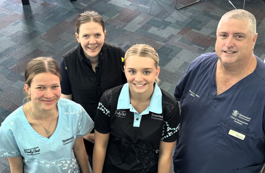 High schoolers Georgia and Tanahia are taking part in health traineeships at the West Moreton Hospital and Health Service. They are pictured with clinical facilitators Robert Winstone and Meg Landers.