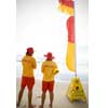 Surf life savers beside the flags