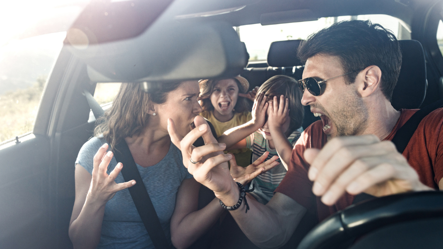 A family of four arguing in their car while heading on holiday