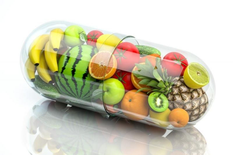 A clear multivitamin capsule contains many kinds of fresh fruit instead of vitamin powder 