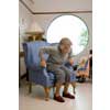 thumbnail image of older woman getting out of a lounge chair