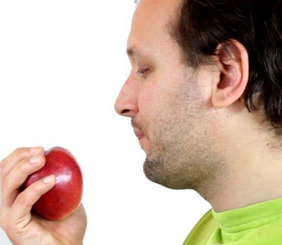 A man preparing to eat an apple