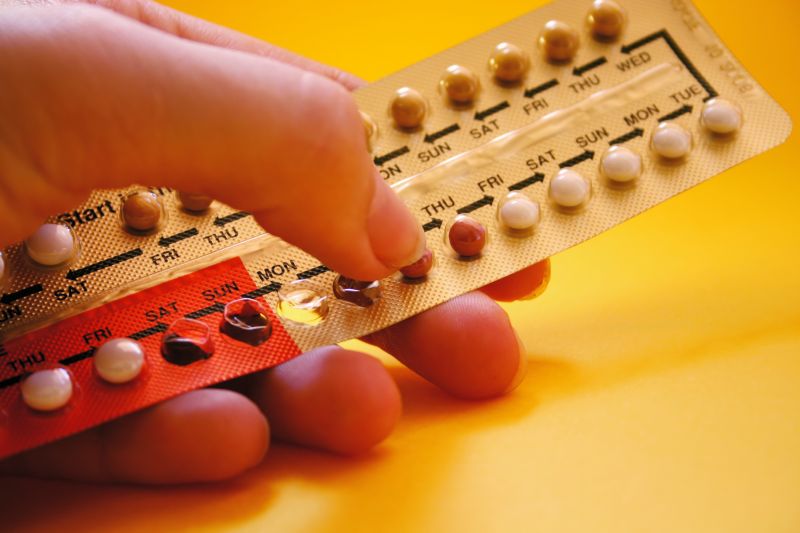 Close up of a pill packet held in a hand.