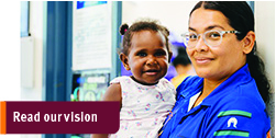 Health worker holding a baby.