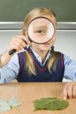 child looking through a magnifying glass