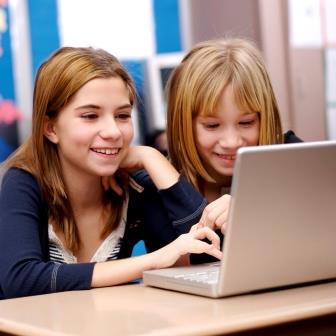 children looking at websites on a laptop