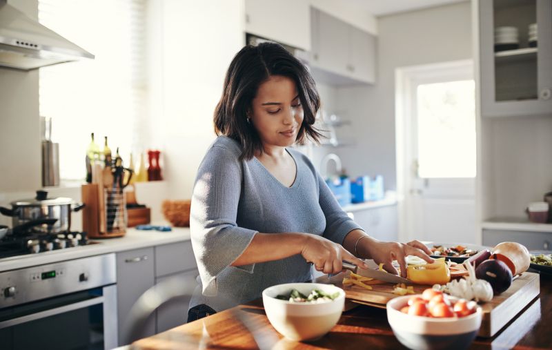 Woman preparing food in her kitchen